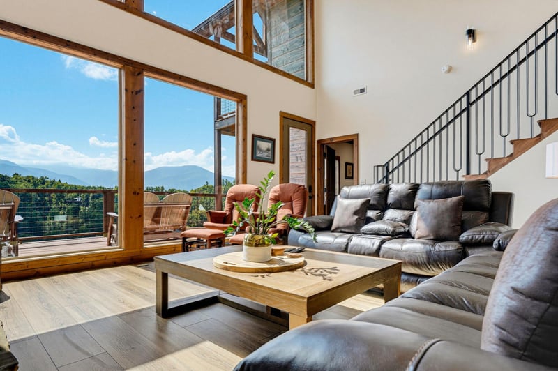 Floortoceiling windows frame stunning mountain vistas while you relax on plush sectional seating. The soaring ceilings and natural wood accents create an airy, inviting retreat perfect for unwinding