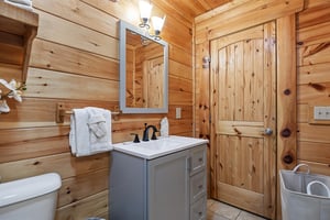 Single vanity sink beside toilet