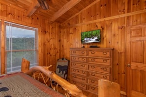 Tall dresser beside rocking chair
