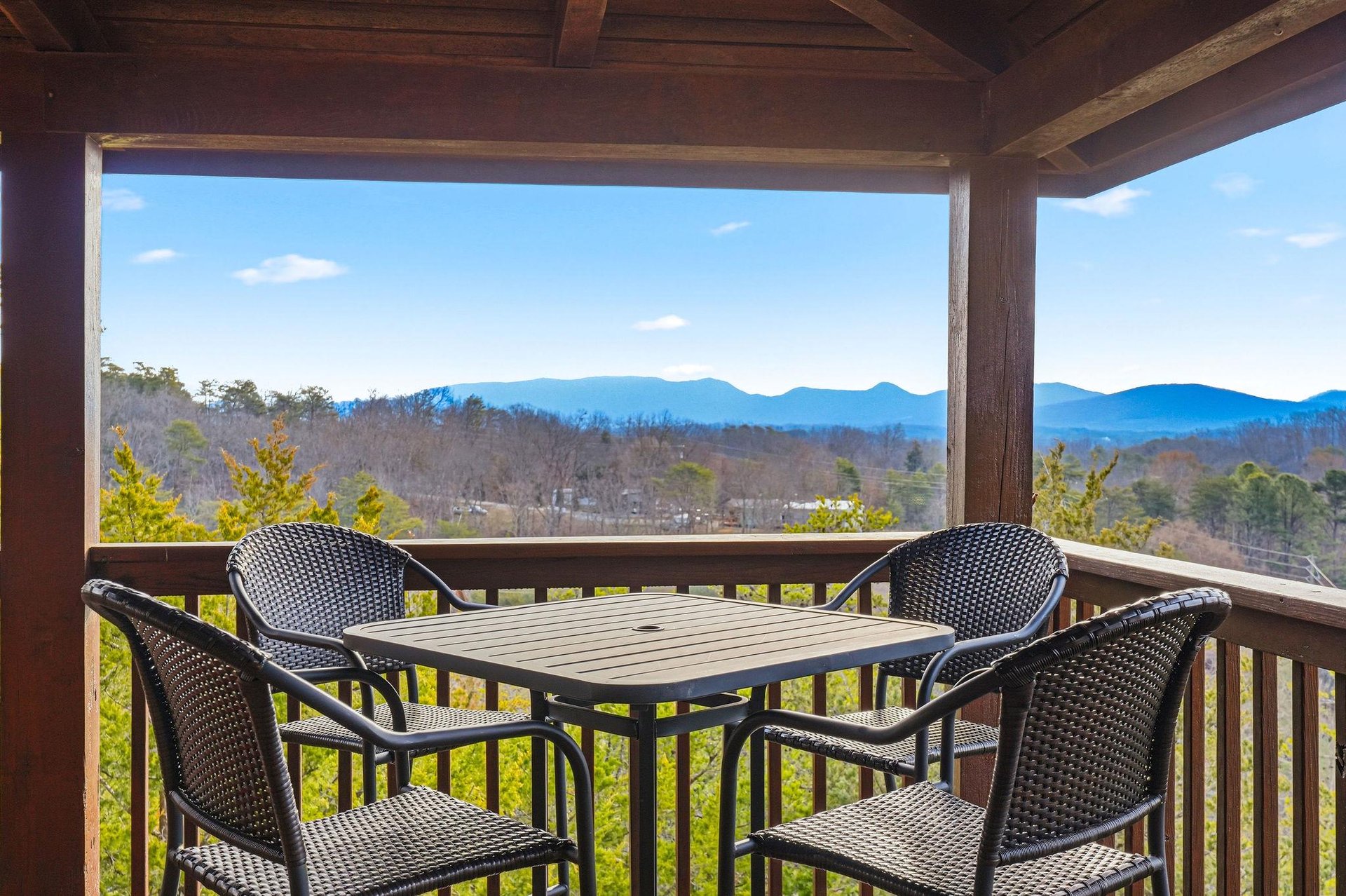 Savor your morning coffee on this covered balcony while gazing at breathtaking mountain views that stretch endlessly before you.