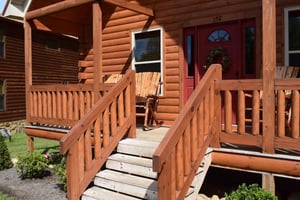 Your rustic log cabin welcomes you with warm wood tones and a charming covered porch, perfect for morning coffee or evening relaxation.