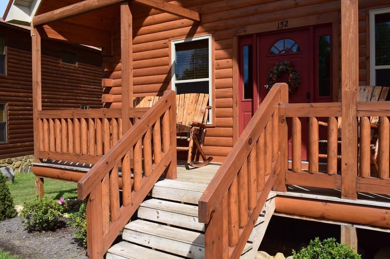 Your rustic log cabin welcomes you with warm wood tones and a charming covered porch, perfect for morning coffee or evening relaxation.