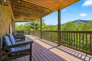 Relax on your private covered deck with seating and take in the lush mountain scenery. Fresh air, peaceful views, and the perfect spot to unwind after exploring the area.