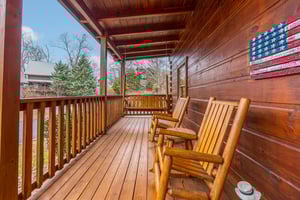Seating on covered deck at Livin Simple, a 2 bedroom cabin rental located in Pigeon Forge
