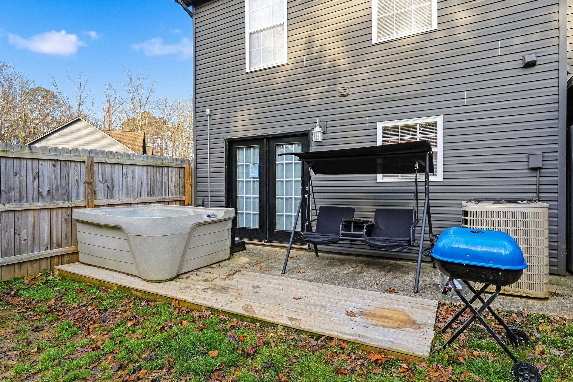 Relax in your private hot tub after grilling on the deck, complete with porch swing for peaceful moments.