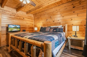 Slip into this handcrafted log bed and let the warmth of natural wood surroundings embrace you after a day of adventure. Your cozy cabin retreat includes a TV for unwinding and rustic charm in every d