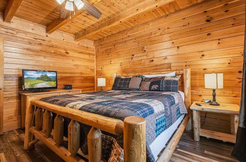 Slip into this handcrafted log bed and let the warmth of natural wood surroundings embrace you after a day of adventure. Your cozy cabin retreat includes a TV for unwinding and rustic charm in every d