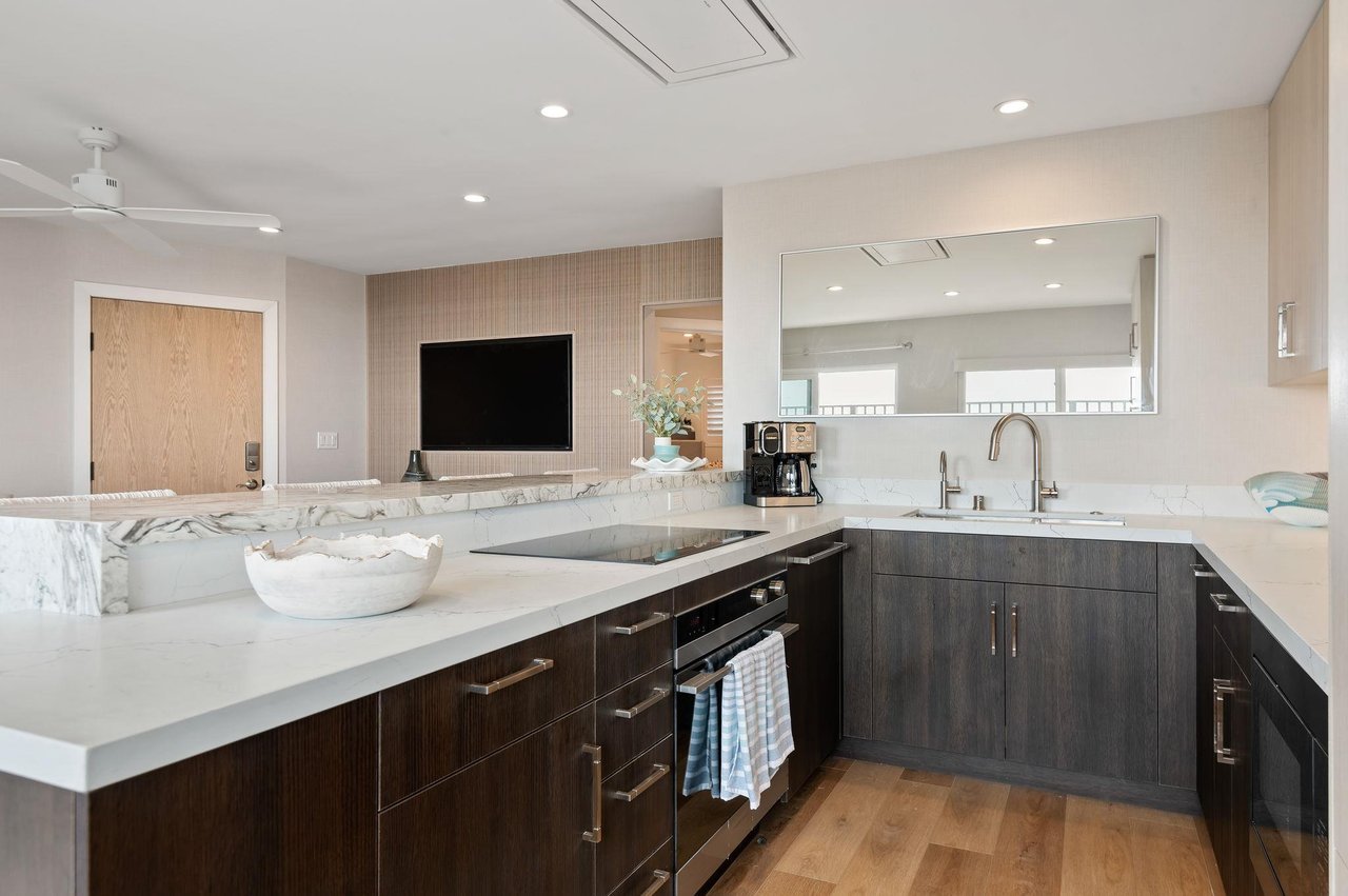 Kitchen view with all appliances and living room view.