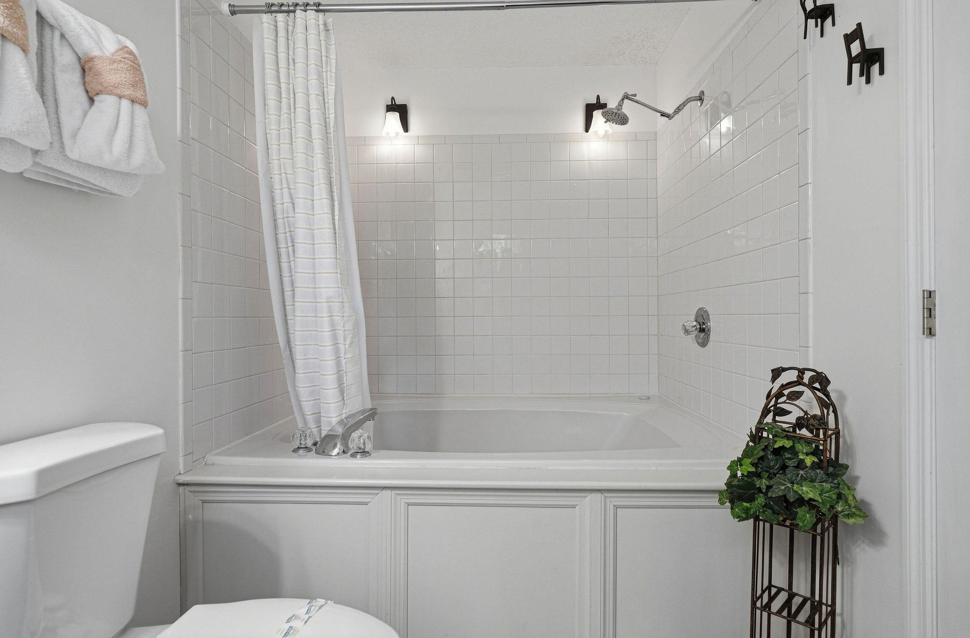Slip into your private bath after a long day—classic white subway tile, dual rainfall showerheads, and soft lighting create a spalike retreat youll love coming home to.