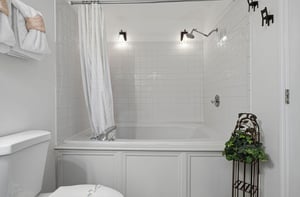 Slip into your private bath after a long day—classic white subway tile, dual rainfall showerheads, and soft lighting create a spalike retreat youll love coming home to.