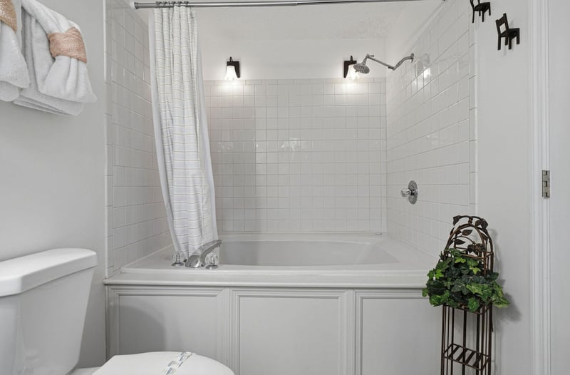 Slip into your private bath after a long day—classic white subway tile, dual rainfall showerheads, and soft lighting create a spalike retreat youll love coming home to.