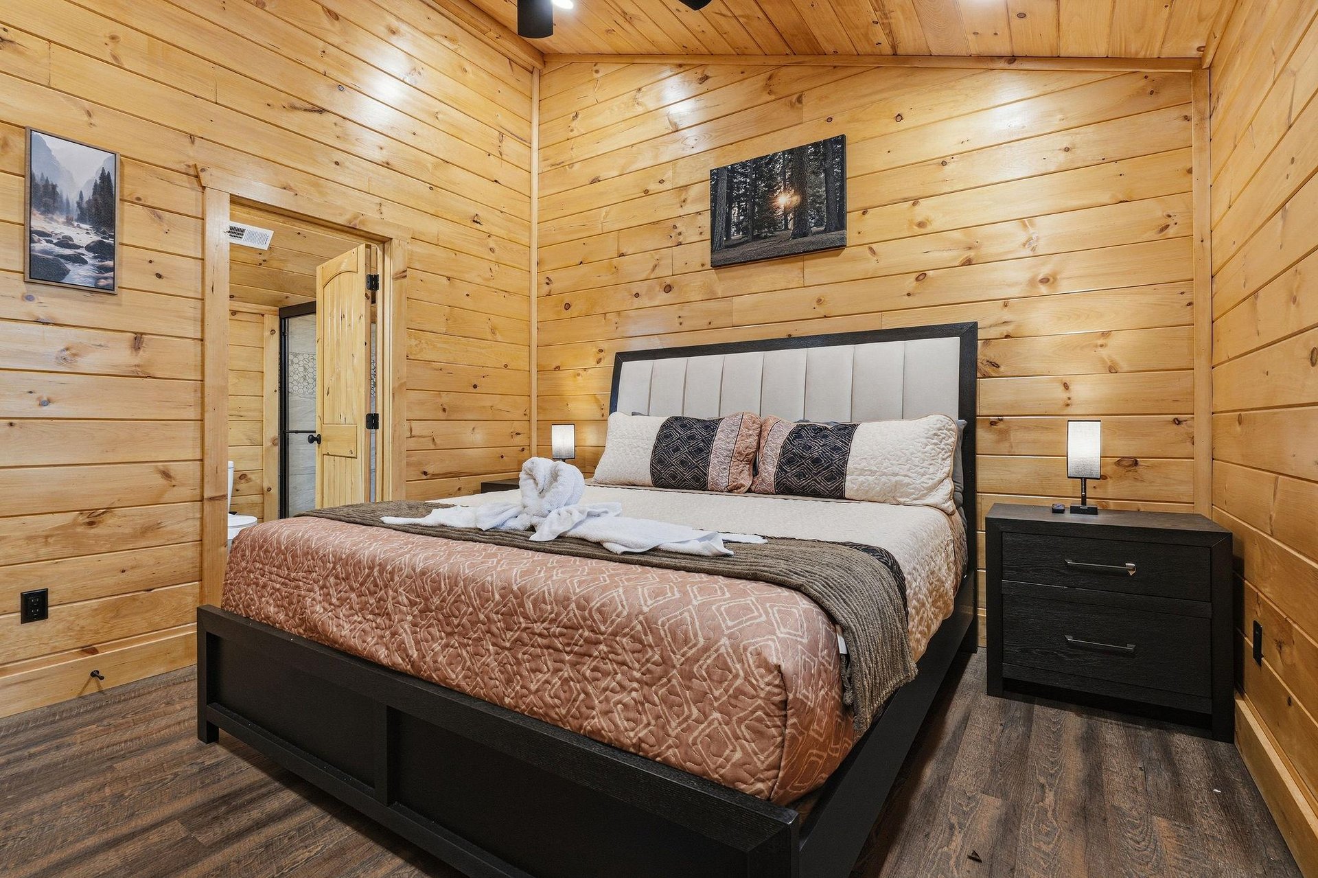 Sink into plush bedding surrounded by warm wood walls that create your perfect mountain retreat sanctuary.