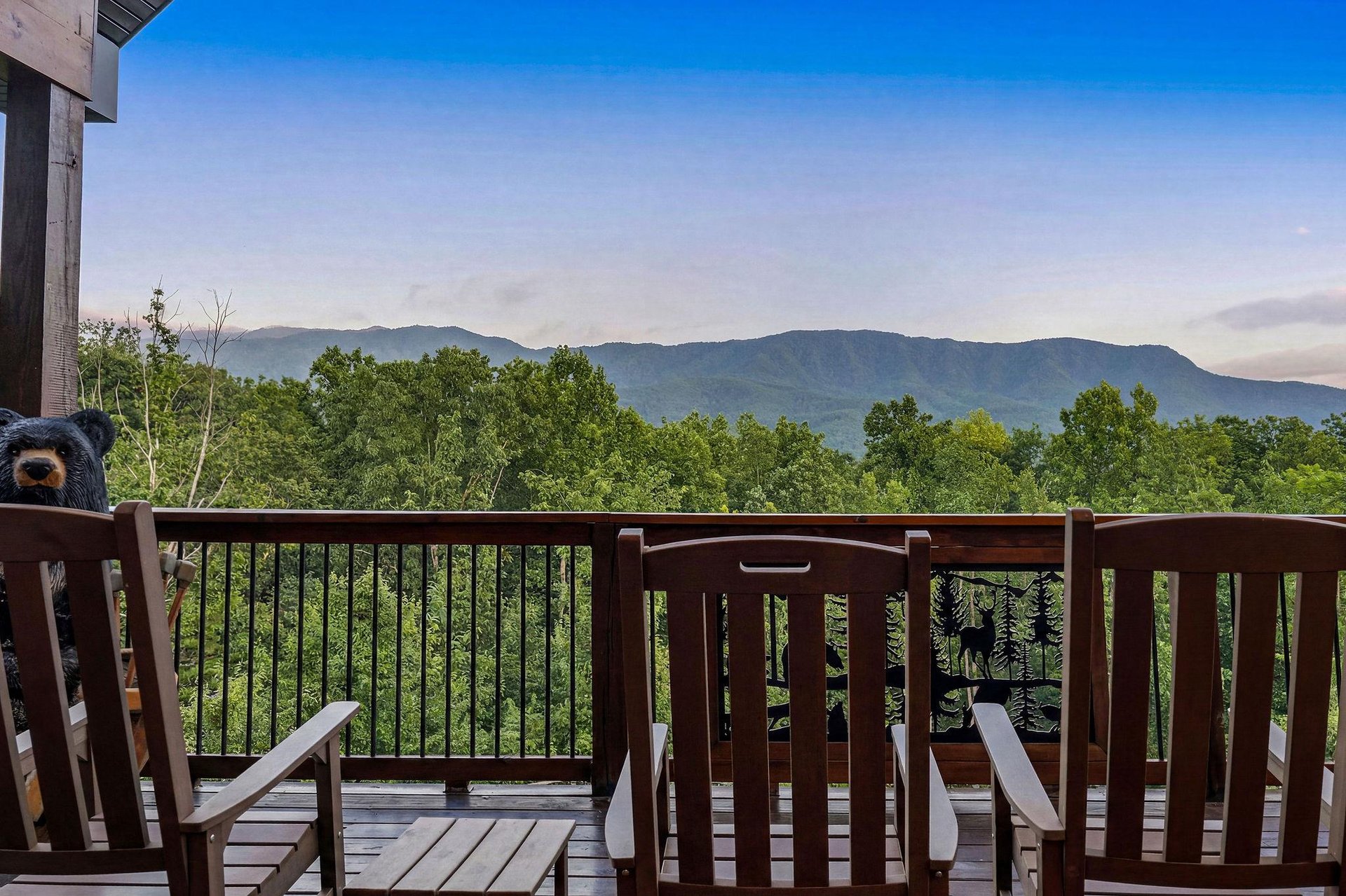 Sweeping mountain vistas frame this peaceful balcony, where morning coffee meets natures grandeur. The forested landscape stretches endlessly, offering a serene backdrop for relaxation and reflection