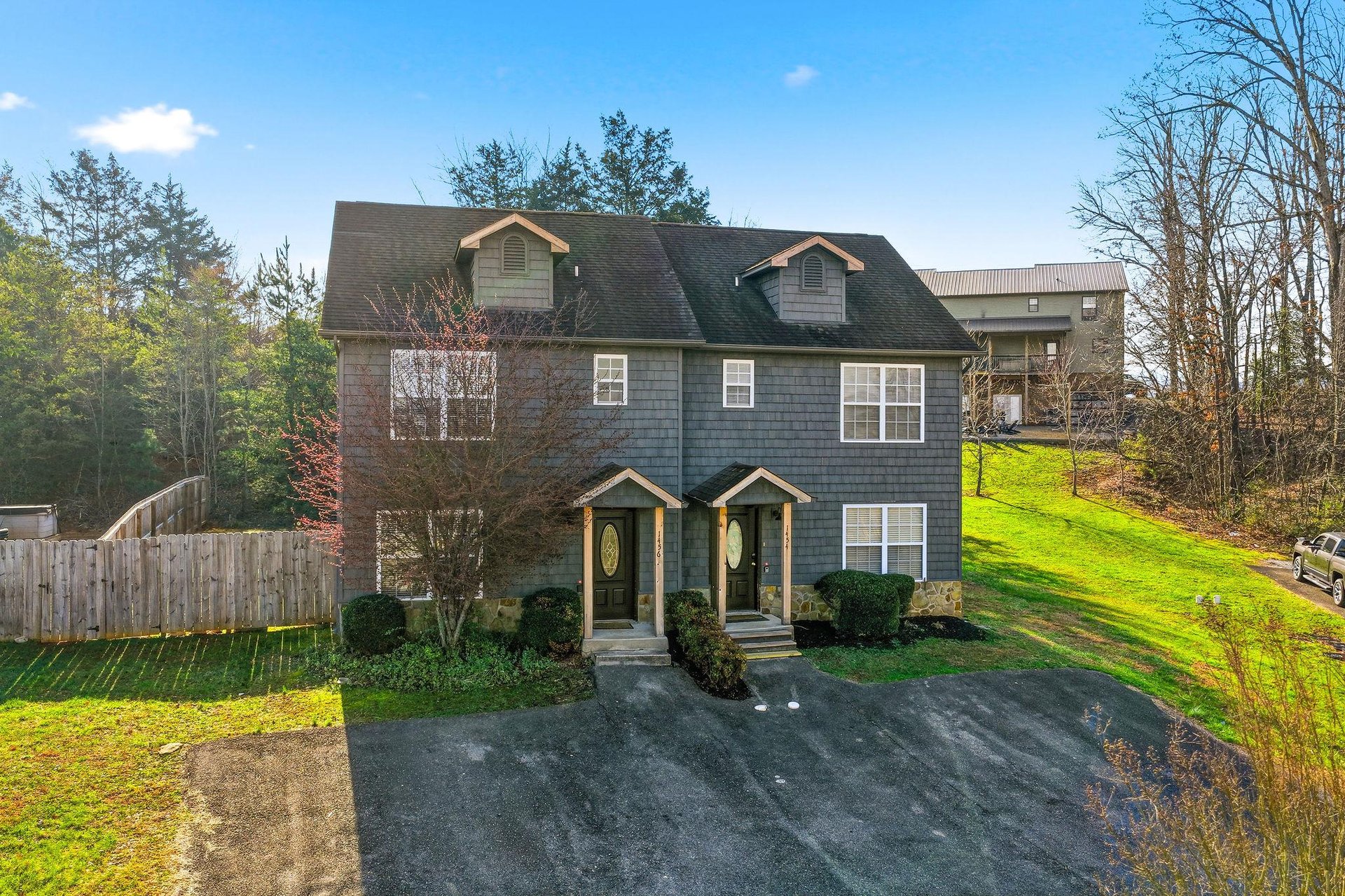 Charming duplexstyle property nestled among mature trees with spacious green lawn and peaceful wooded surroundings.