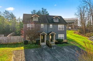 Charming duplexstyle property nestled among mature trees with spacious green lawn and peaceful wooded surroundings.