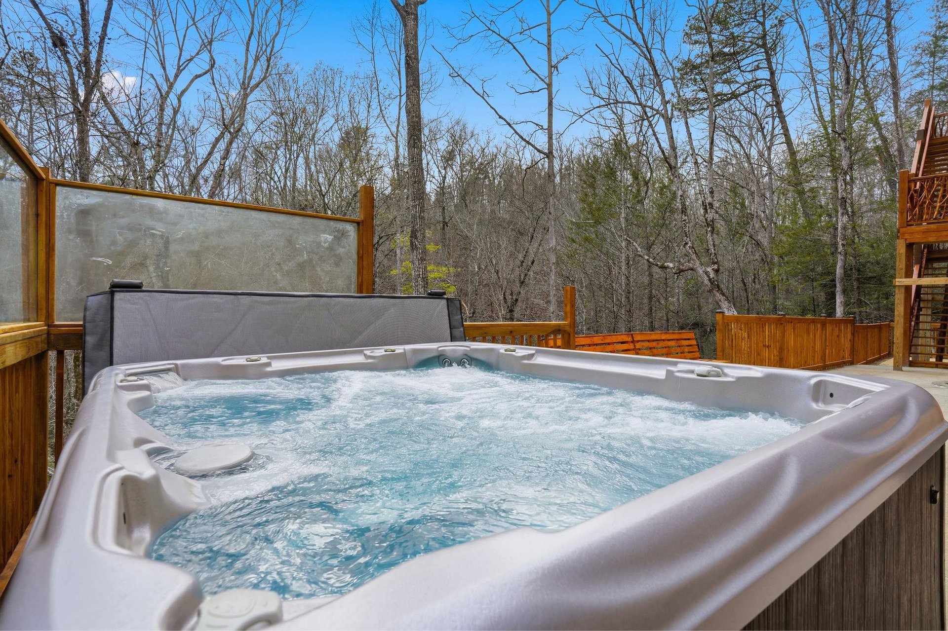 Soak away your stress in this bubbling hot tub, surrounded by peaceful forest views on your private deck.
