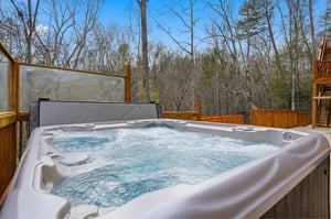 Soak away your stress in this bubbling hot tub, surrounded by peaceful forest views on your private deck.