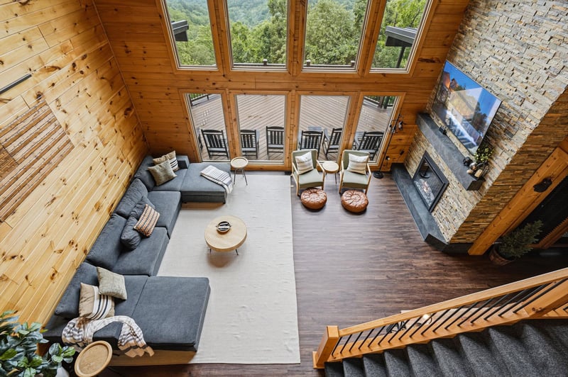 Picture yourself relaxing in this stunning living room, where floortoceiling windows frame breathtaking mountain views. Sink into the plush sectional by the cozy fireplace and unwind in your private