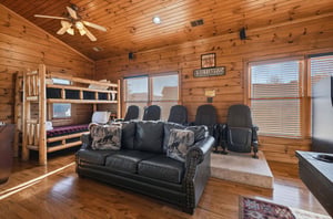 Rustic charm meets entertainment—unwind on plush leather seating, cozy up on the bunk bed, and enjoy your favorite movies in your private theater room with rich wood details.