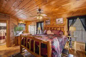 Cozy log cabin bedroom with handcrafted wood furnishings, plaid bedding, and rustic charm creates your perfect mountain retreat.