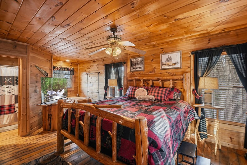 Cozy log cabin bedroom with handcrafted wood furnishings, plaid bedding, and rustic charm creates your perfect mountain retreat.