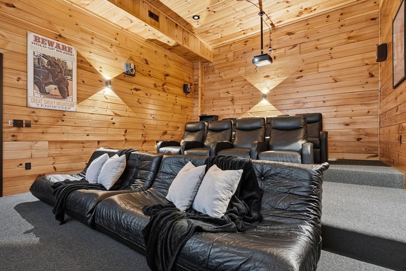 Sink into plush leather recliners in your private home theater, where warm wood walls create the perfect cozy escape for movie nights with your favorite people.