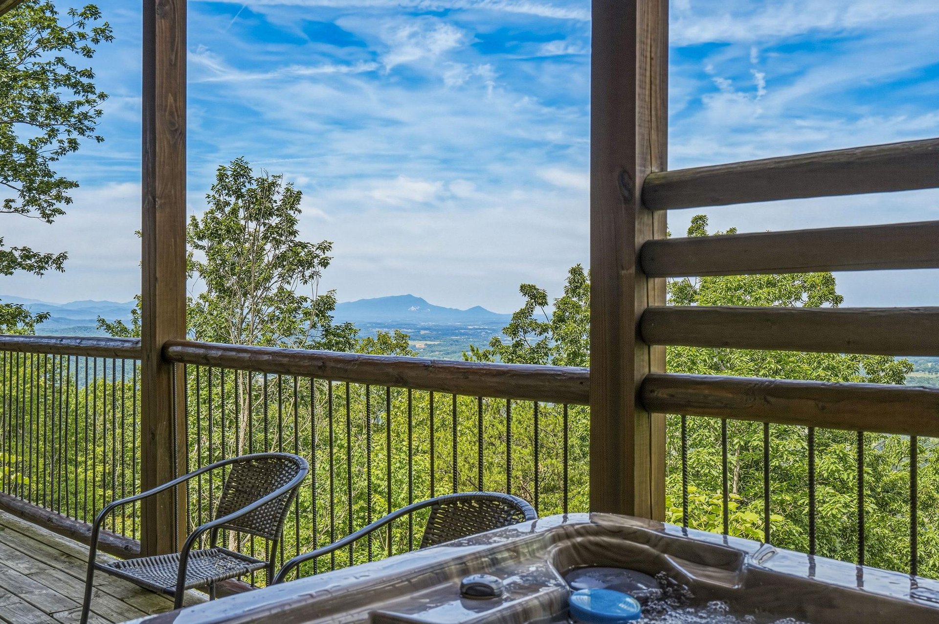 Soak in the hot tub and drink in sweeping mountain vistas—your private deck frames lush forests and distant peaks, offering the perfect escape to unwind and reconnect with nature.