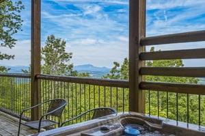 Soak in the hot tub and drink in sweeping mountain vistas—your private deck frames lush forests and distant peaks, offering the perfect escape to unwind and reconnect with nature.