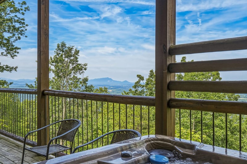 Soak in the hot tub and drink in sweeping mountain vistas—your private deck frames lush forests and distant peaks, offering the perfect escape to unwind and reconnect with nature.