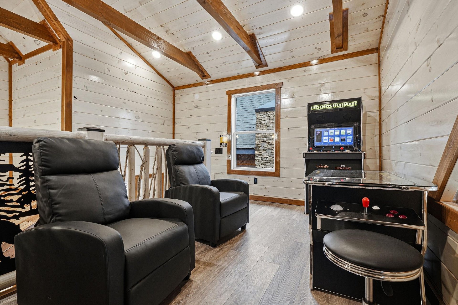 Unwind in your private game room with plush leather recliners and classic arcade entertainment for endless fun.
