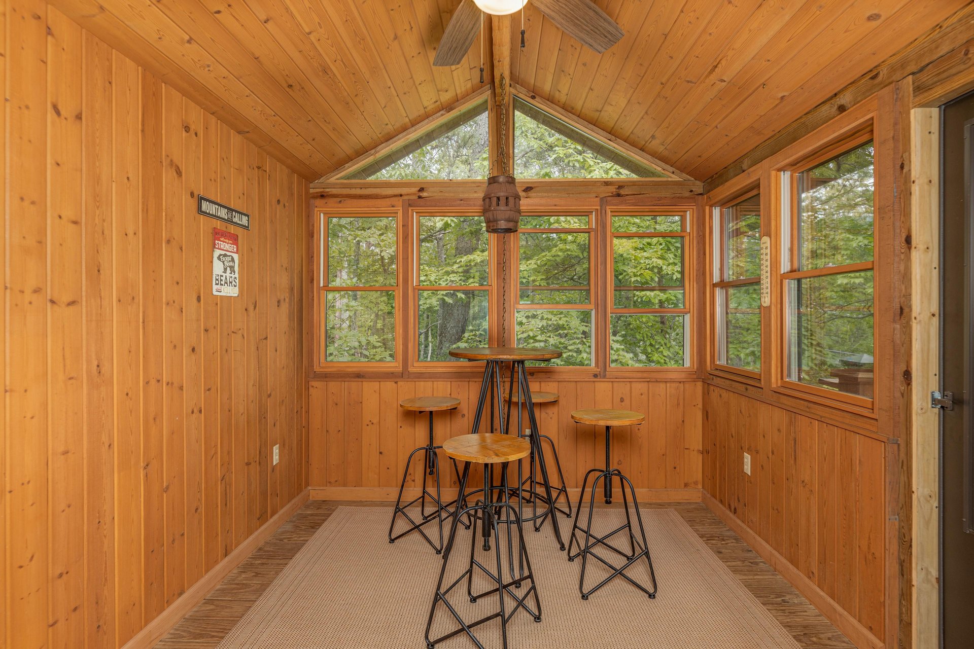 Sunroom with seating for four at Cubs Crib, a 3 bedroom cabin rental located in Gatlinburg