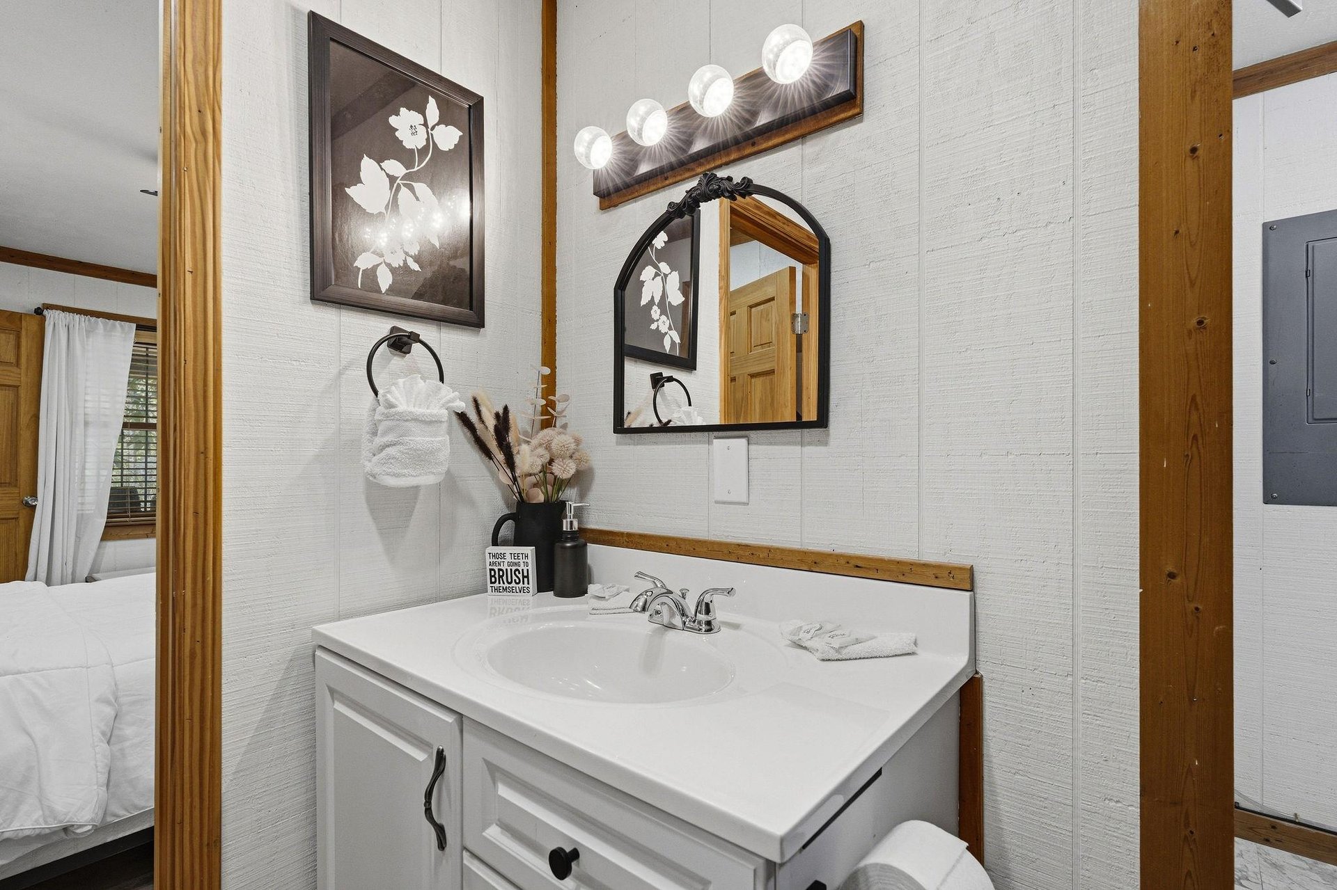 Step into your stylish bathroom featuring rustic charm with modern touches, complete vanity, and thoughtful amenities for your comfort.