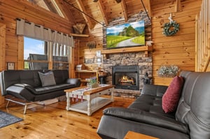 Living room with 2 futons and stone fireplace