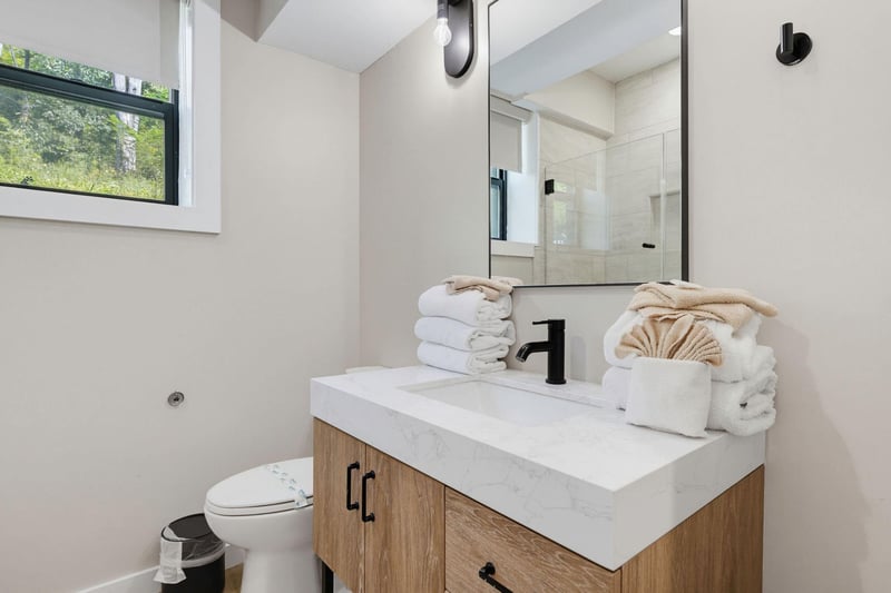 Freshen up in your bright, modern bathroom with sleek fixtures and spastyle touches. Plush towels await, and natural light adds a welcoming glow.