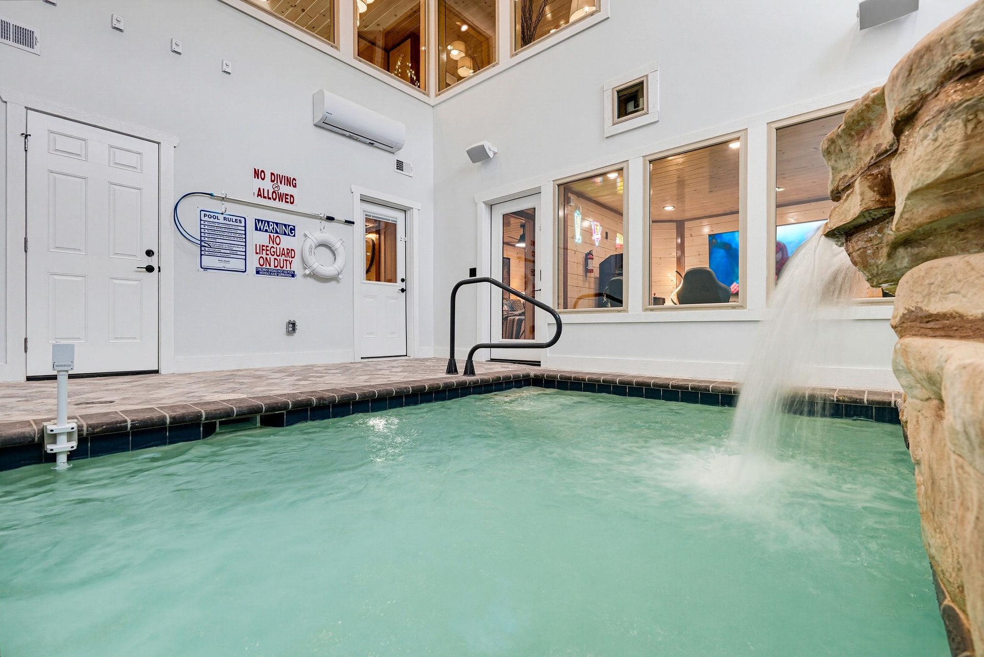 Dive into your private indoor pool with a soothing stone waterfall, climatecontrolled comfort, and a warm, resortstyle ambiance just steps from your door.