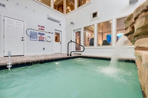 Dive into your private indoor pool with a soothing stone waterfall, climatecontrolled comfort, and a warm, resortstyle ambiance just steps from your door.