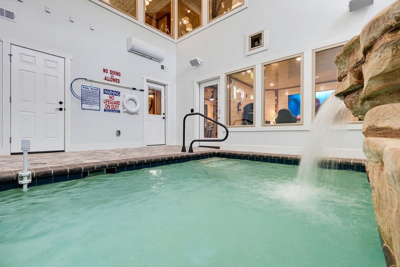 Dive into your private indoor pool with a soothing stone waterfall, climatecontrolled comfort, and a warm, resortstyle ambiance just steps from your door.