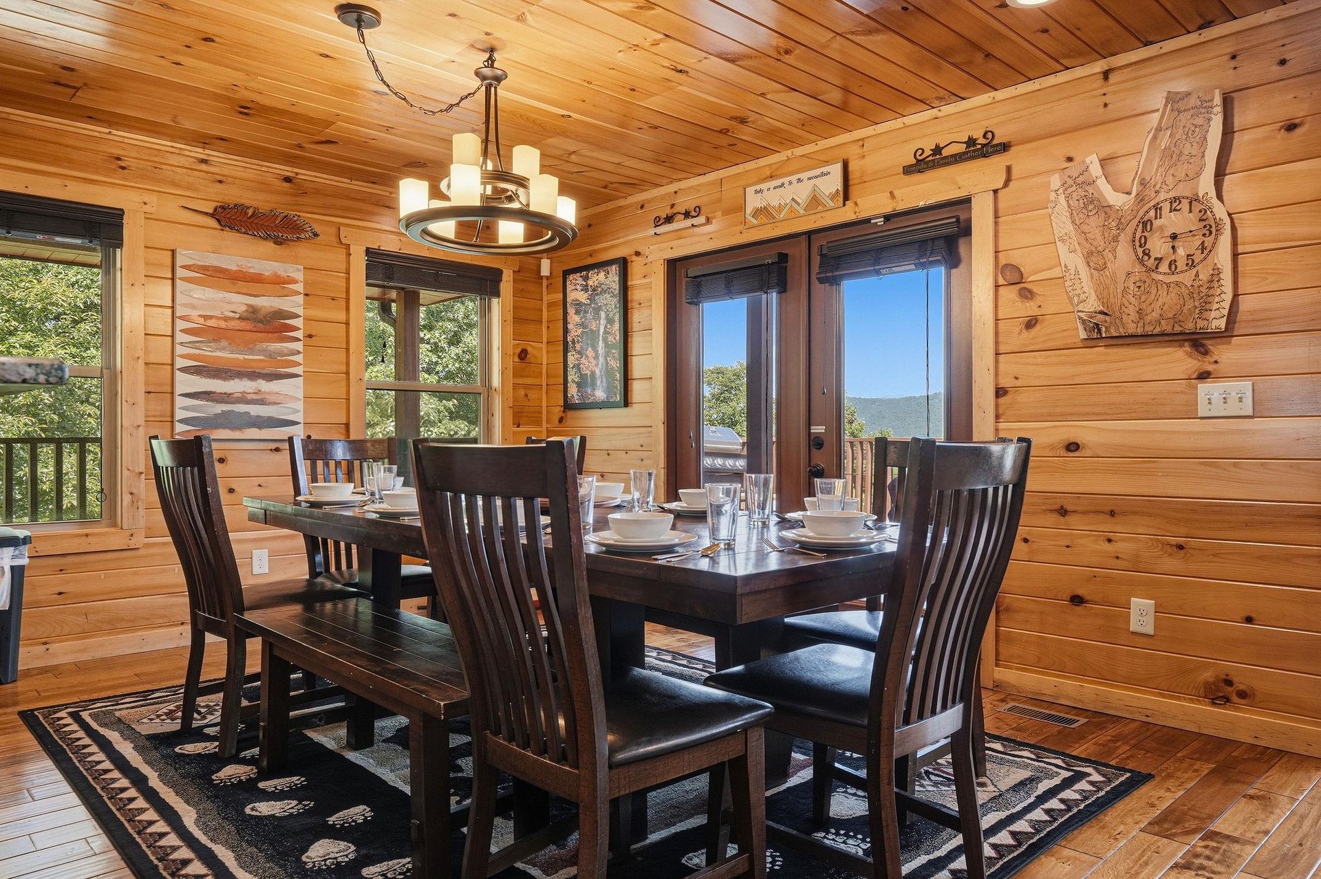 Gather around this rustic dining table with mountain views framing your meals. The warm wood walls and thoughtful decor create an inviting space where your group can share stories over homecooked fea