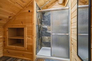 Step into your private spa retreat, with a modern glassenclosed shower and a cozy wooden sauna ready to melt away your stress after a day of adventure.