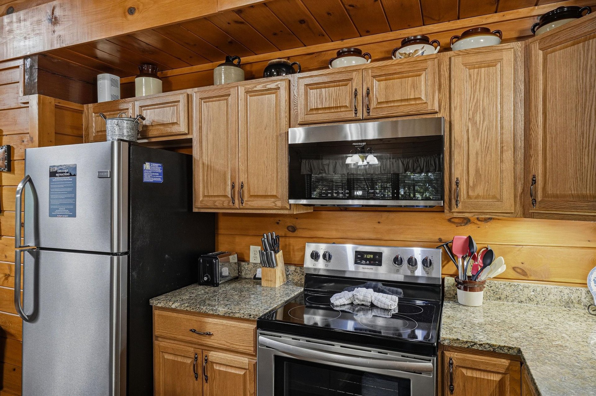 Step into your fullyequipped kitchen, where warm wood cabinets and modern stainless steel appliances make preparing meals a breeze. Everything you need is right at your fingertips in this cozy, rusti