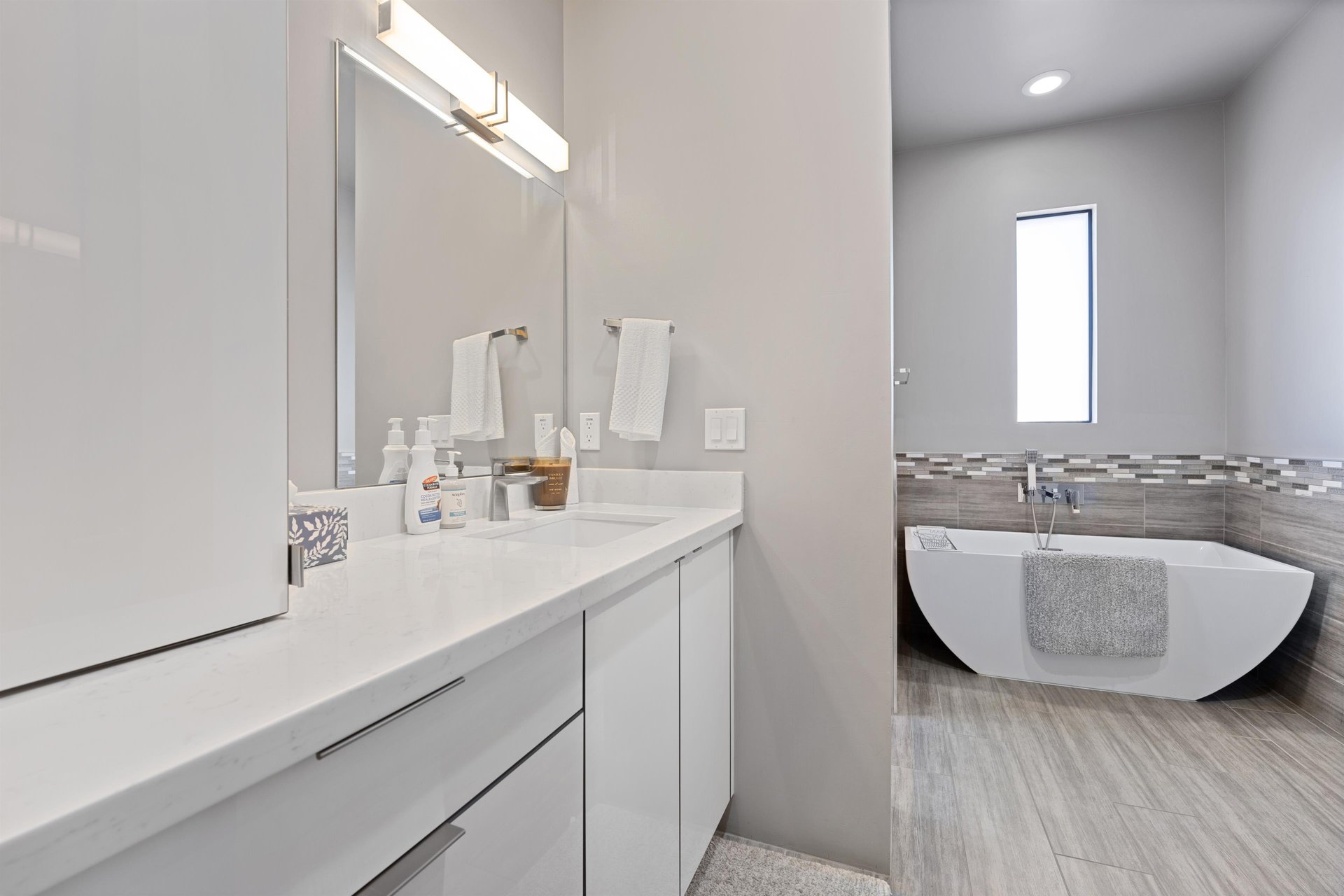 Full bathroom with stand alone tub, walkin shower, and modern fixtures.