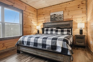 Drift off in your cozy log cabin bedroom, where rustic wood walls meet modern comfort and natural light filters through your window.