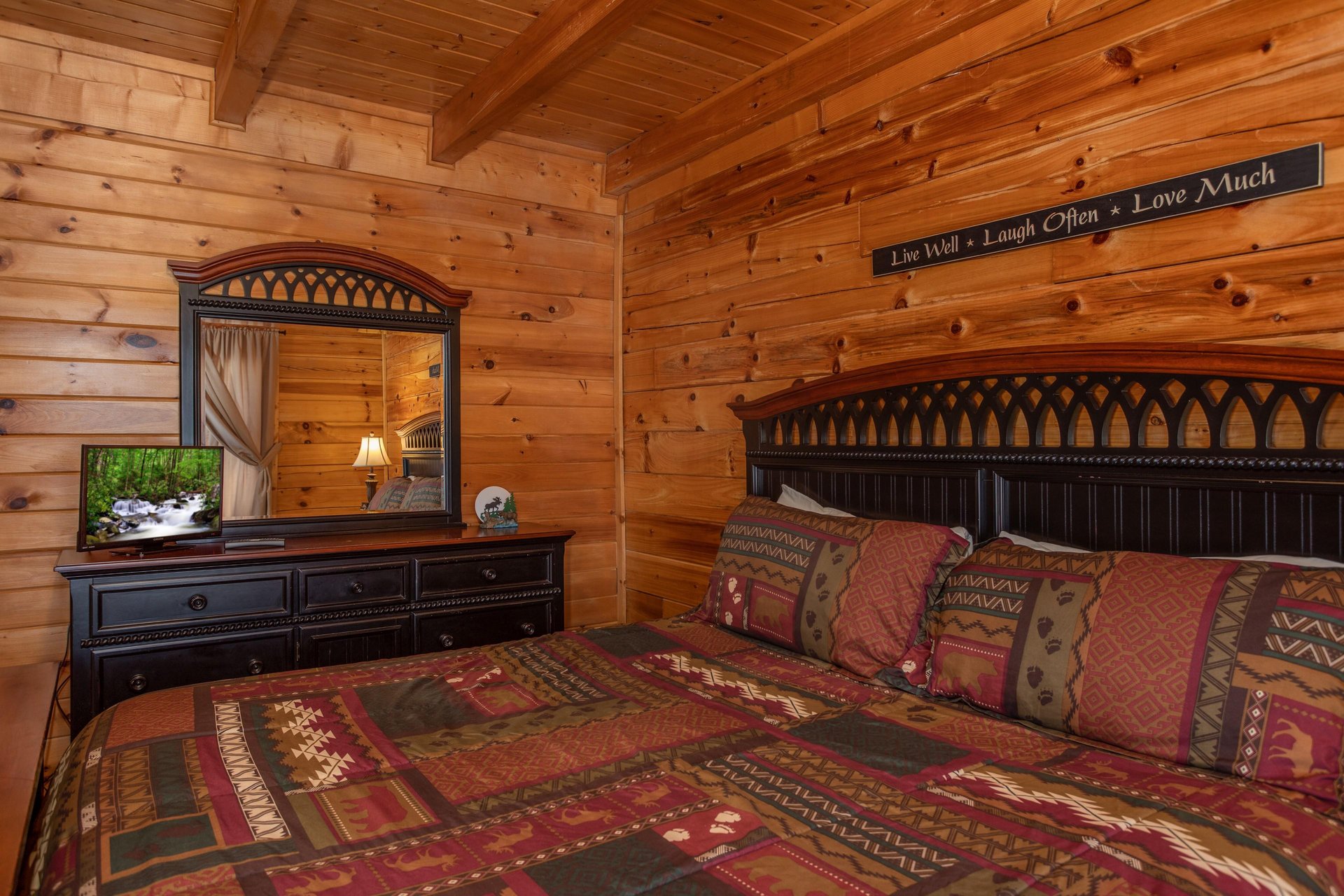 Dresser, mirror, and TV in a bedroom at Momma Bear, a 2 bedroom cabin rental located in Pigeon Forge