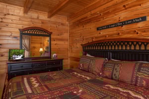 Dresser, mirror, and TV in a bedroom at Momma Bear, a 2 bedroom cabin rental located in Pigeon Forge