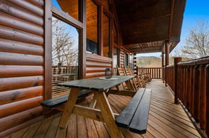 Step onto your private deck where mountain views and fresh air await. Perfect for morning coffee or evening conversations on this peaceful covered terrace.