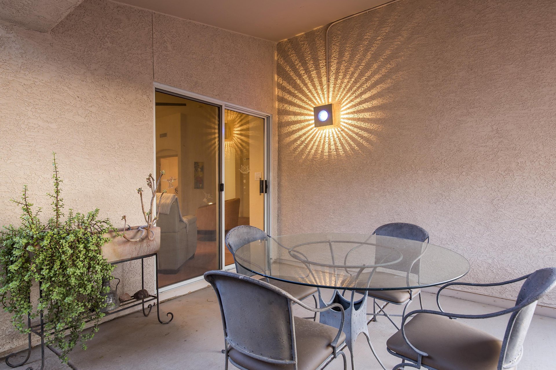 Patio just off of the living room with outdoor dining table and chairs.