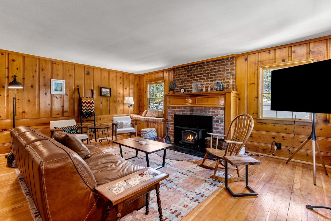 Ample seating, fireplace, and flatscreen TV.