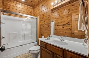 Freshen up in your private bathroom featuring warm wood walls, a roomy tubshower combo, and fluffy towels waiting just for you.