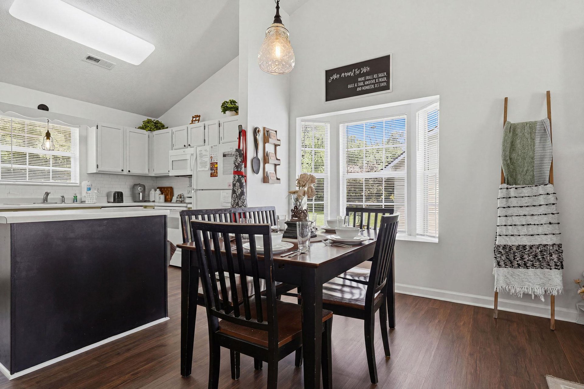 Gather around the welcoming dining table in this bright, openconcept space where natural light streams through large windows. The modern kitchen with sleek cabinetry stands ready for your homecooked