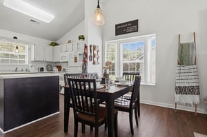 Gather around the welcoming dining table in this bright, openconcept space where natural light streams through large windows. The modern kitchen with sleek cabinetry stands ready for your homecooked